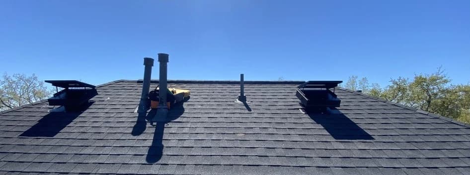 Roof line view of an installed solar attic fan on a residential home